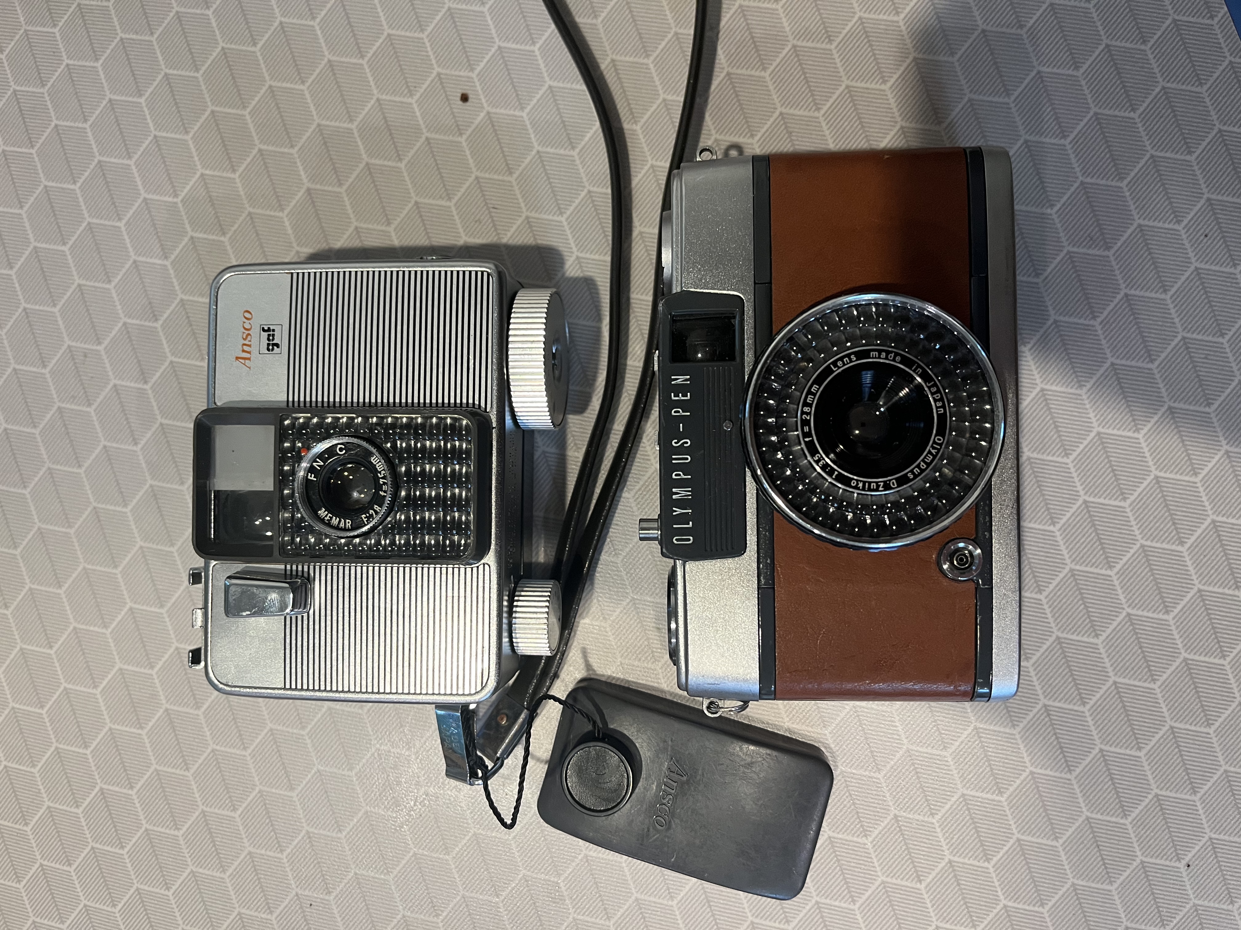 ansco memo ii next to an olympus pen